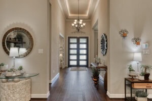 Elegant home entryway with chandelier and decor