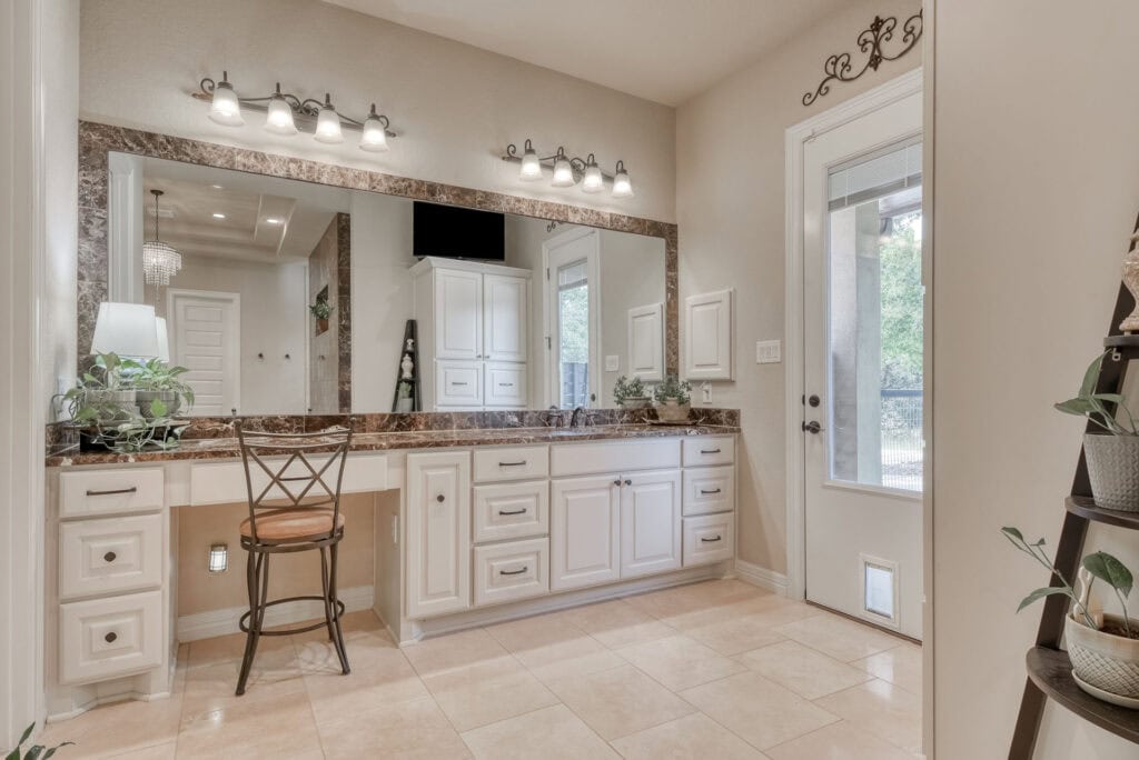 Spacious bathroom with modern vanity and large mirror.