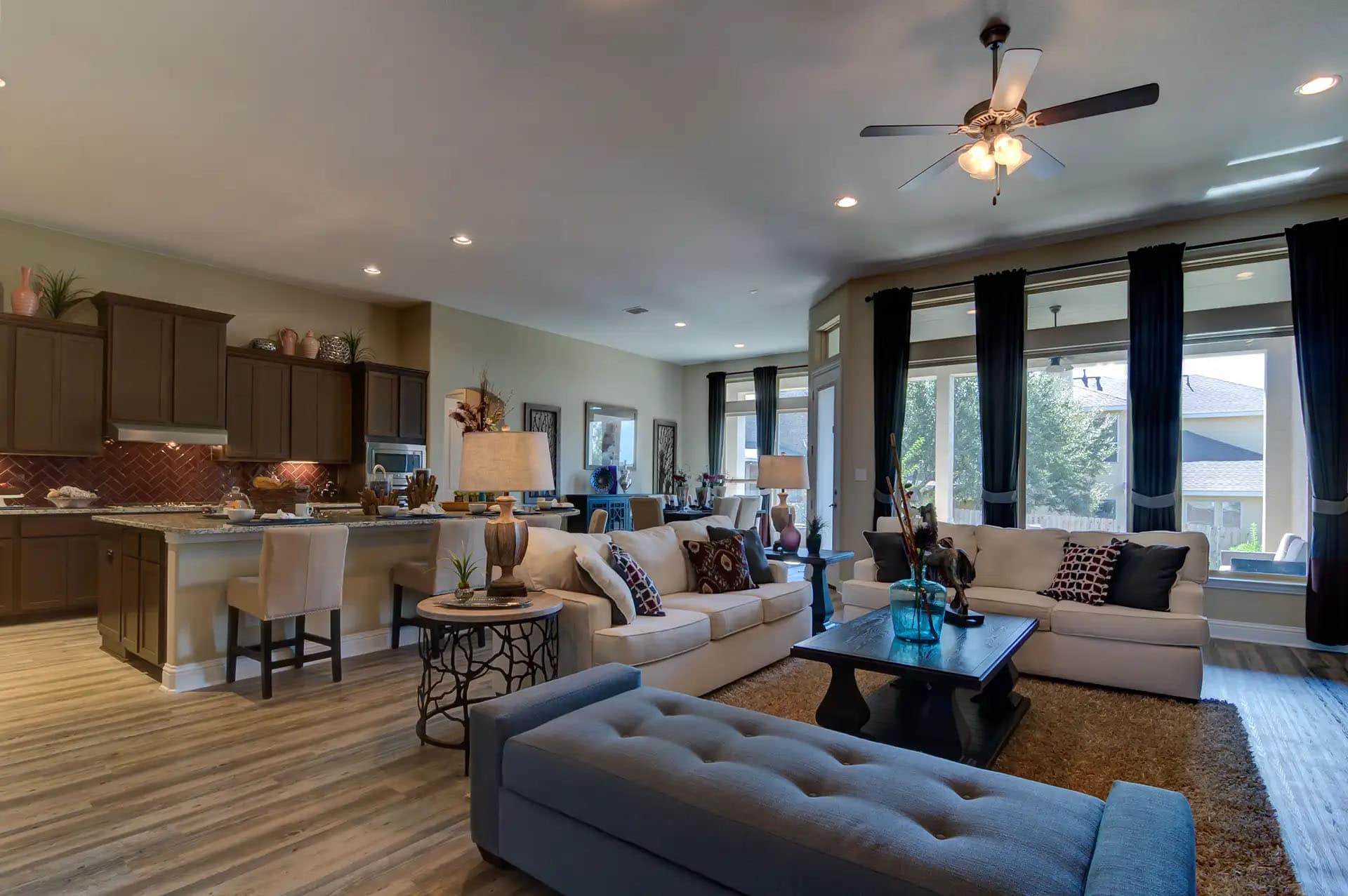 Spacious modern living room with kitchen view.