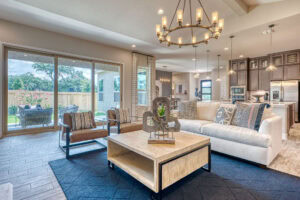 Modern living room with large windows and decor.