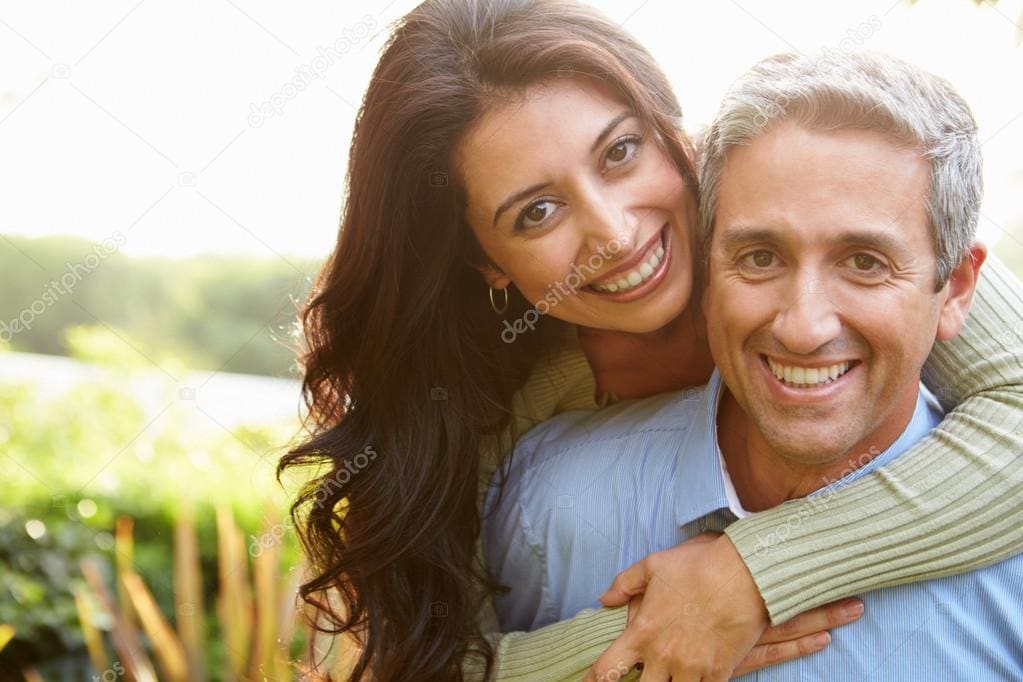 Smiling couple embracing outdoors