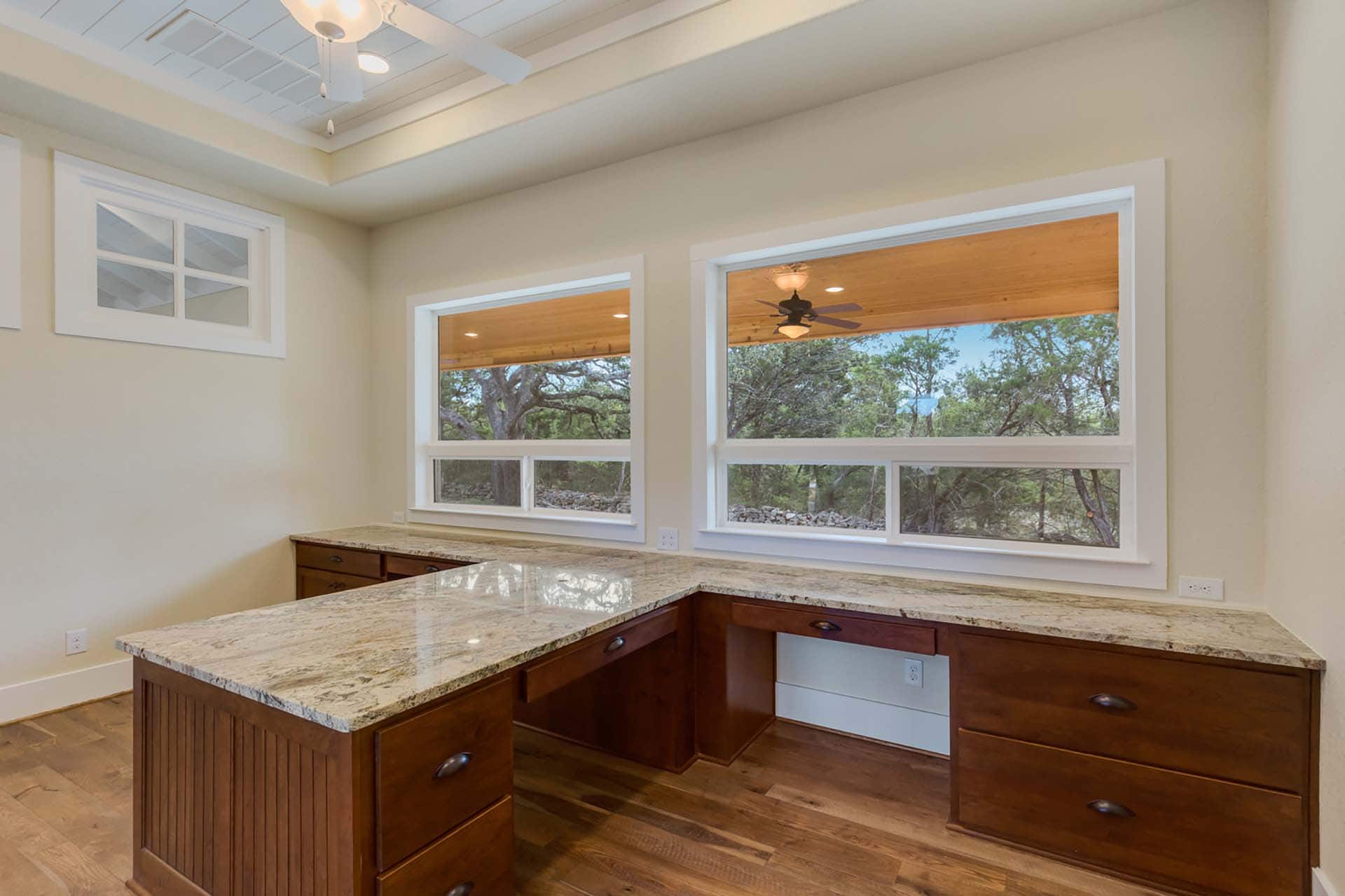 Office with large windows and wooden desk