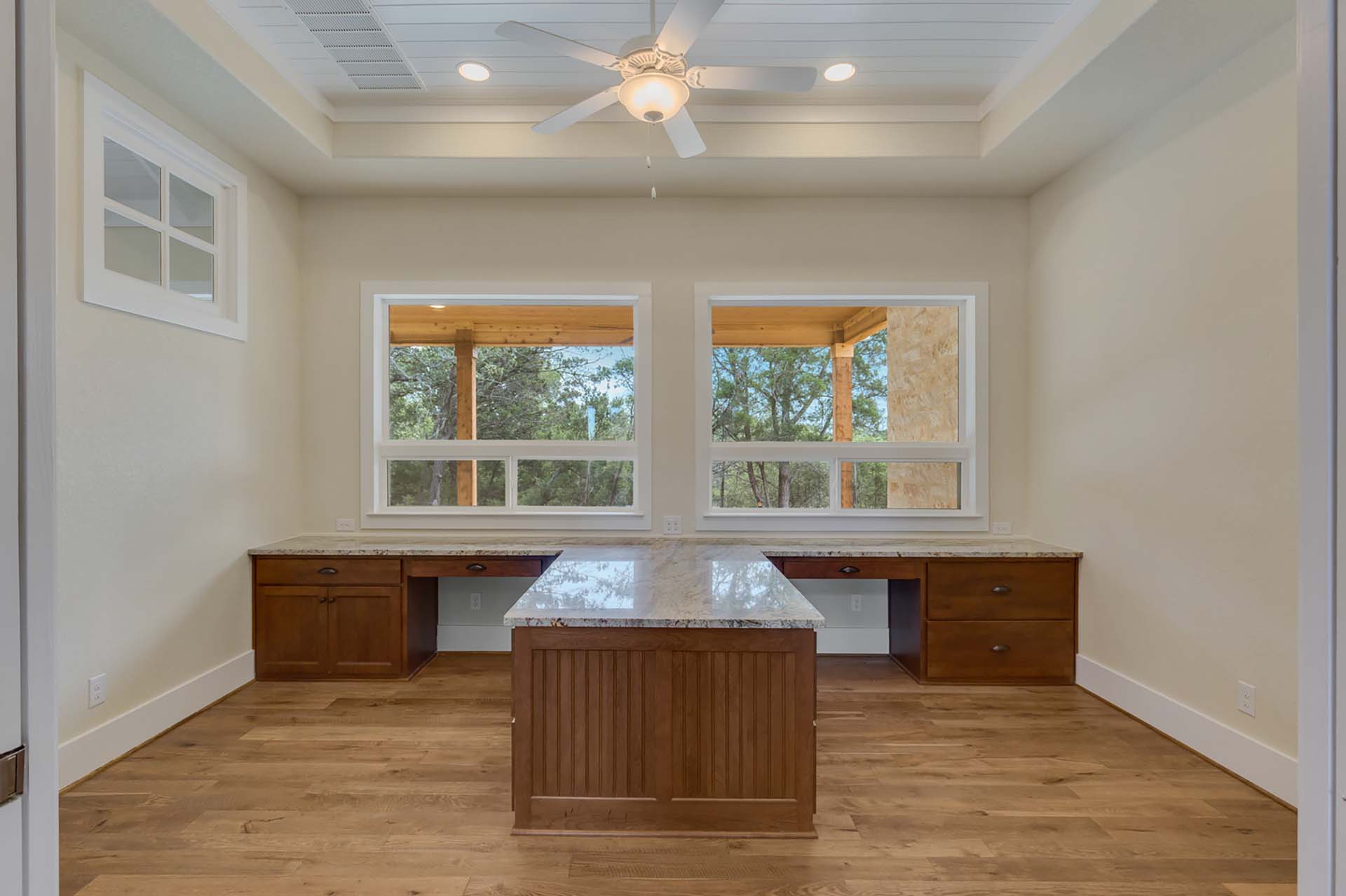 Spacious home office with two large windows