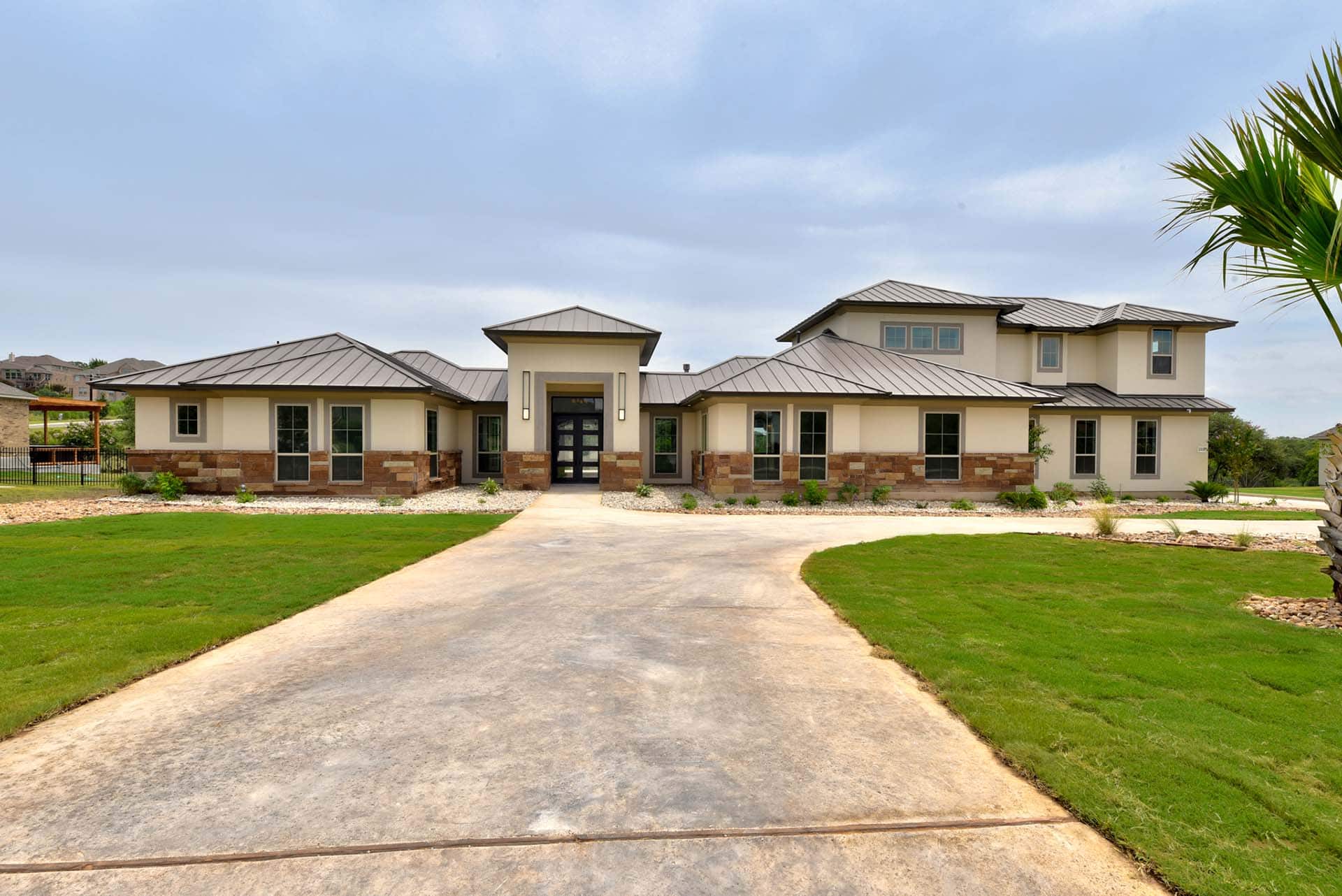 Modern suburban home with manicured lawn and driveway.