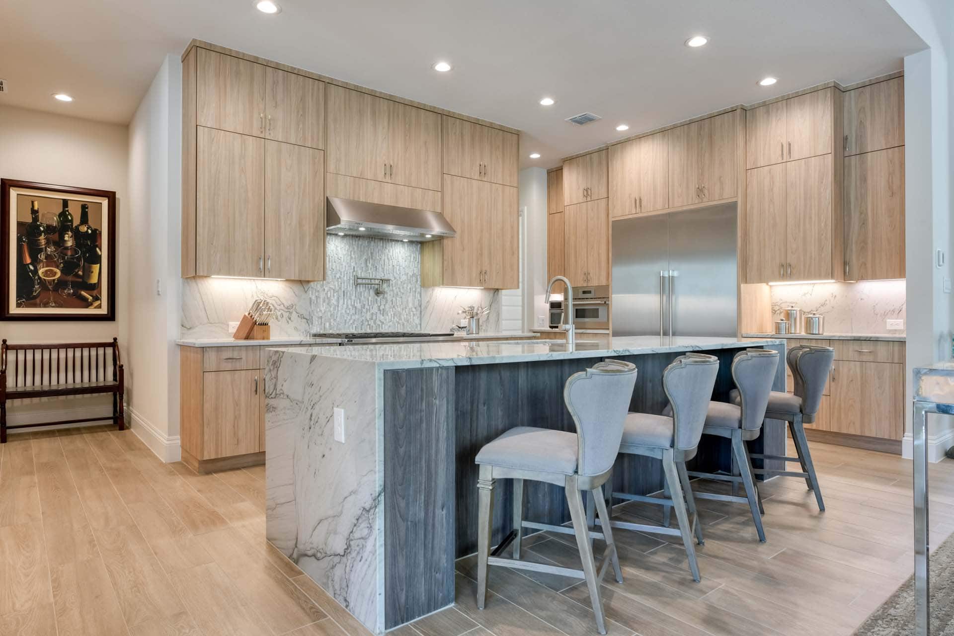 Modern kitchen with island and barstools.