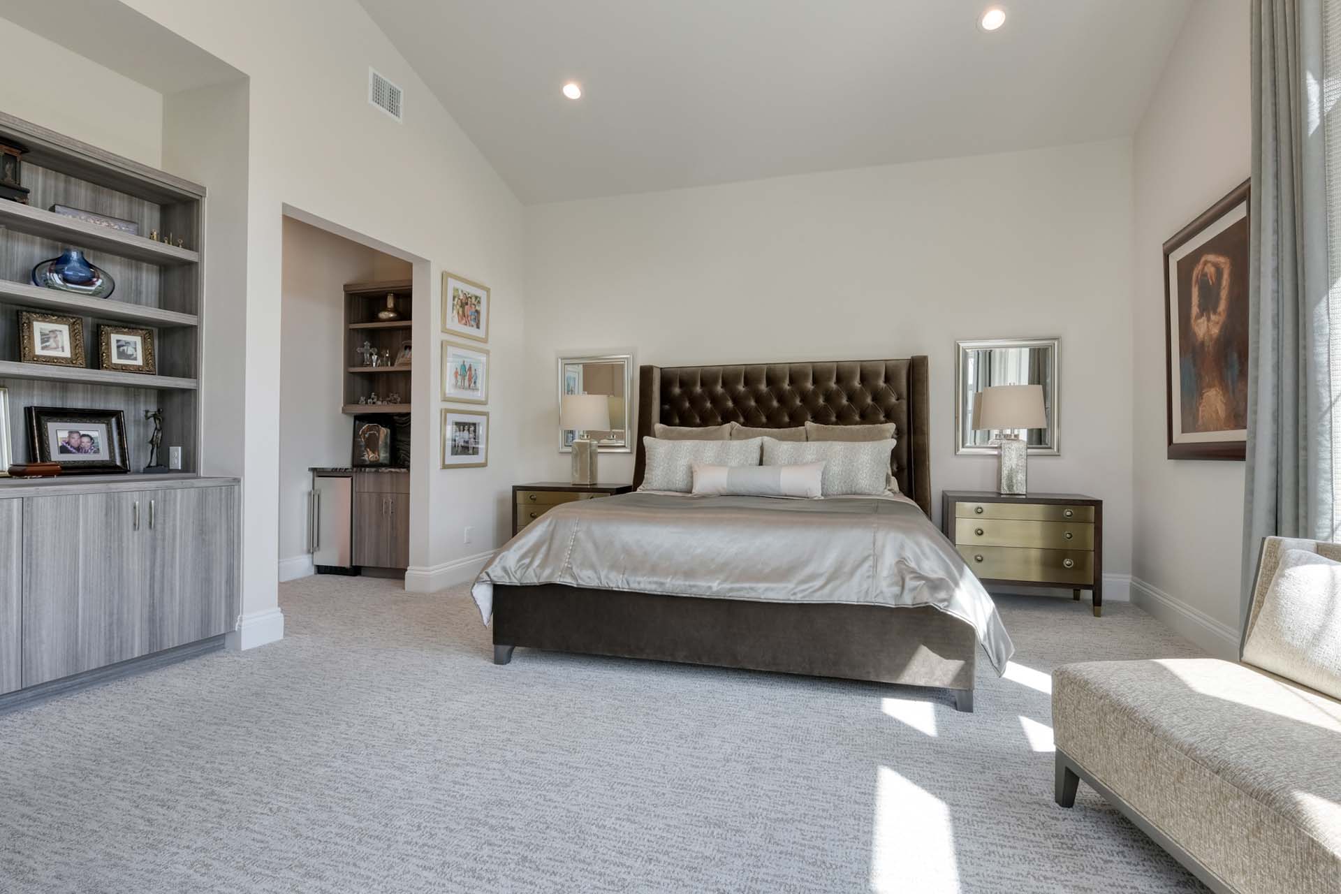 Modern bedroom with bed, lamps, and decor.