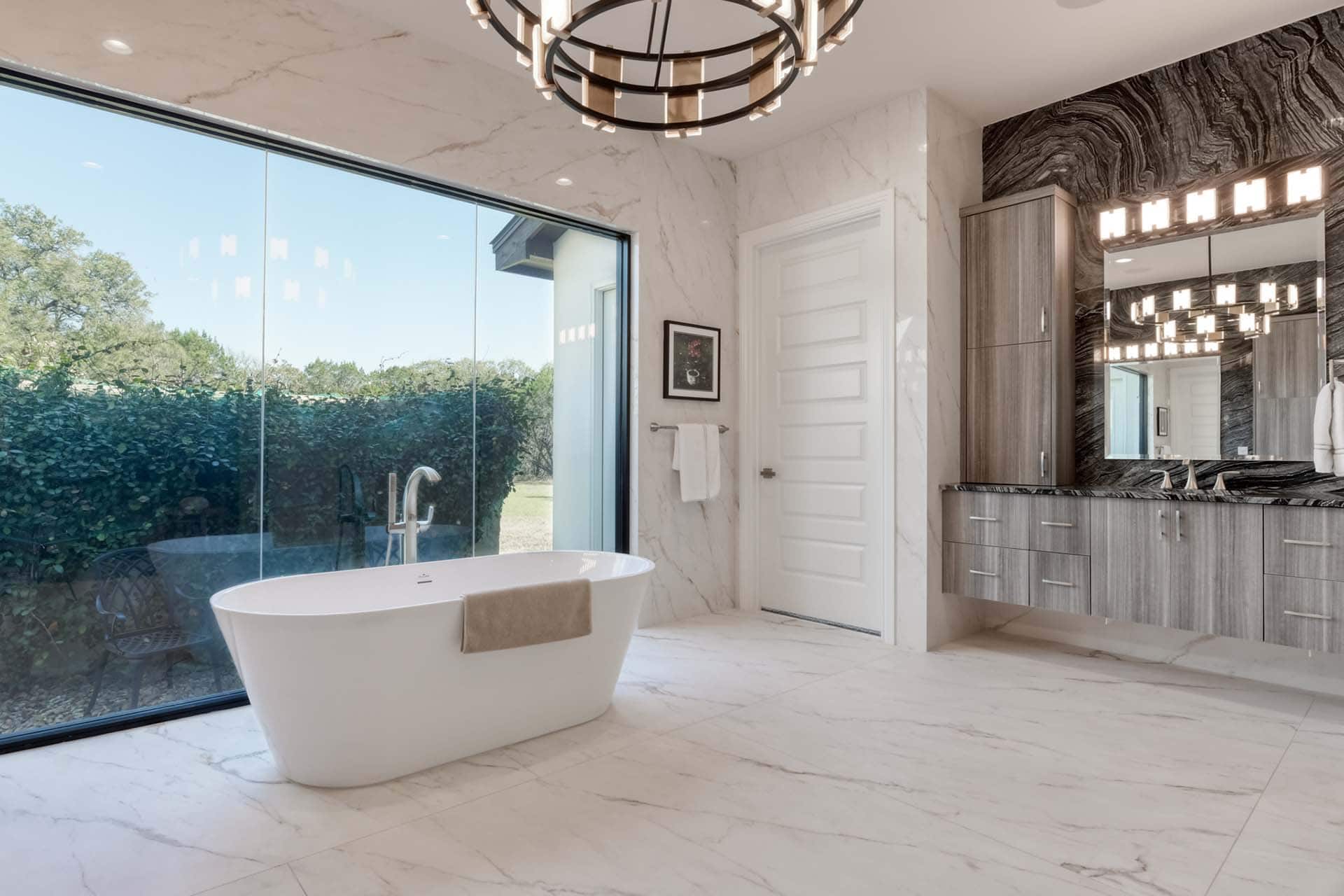 Luxurious bathroom with soaking tub and large window.