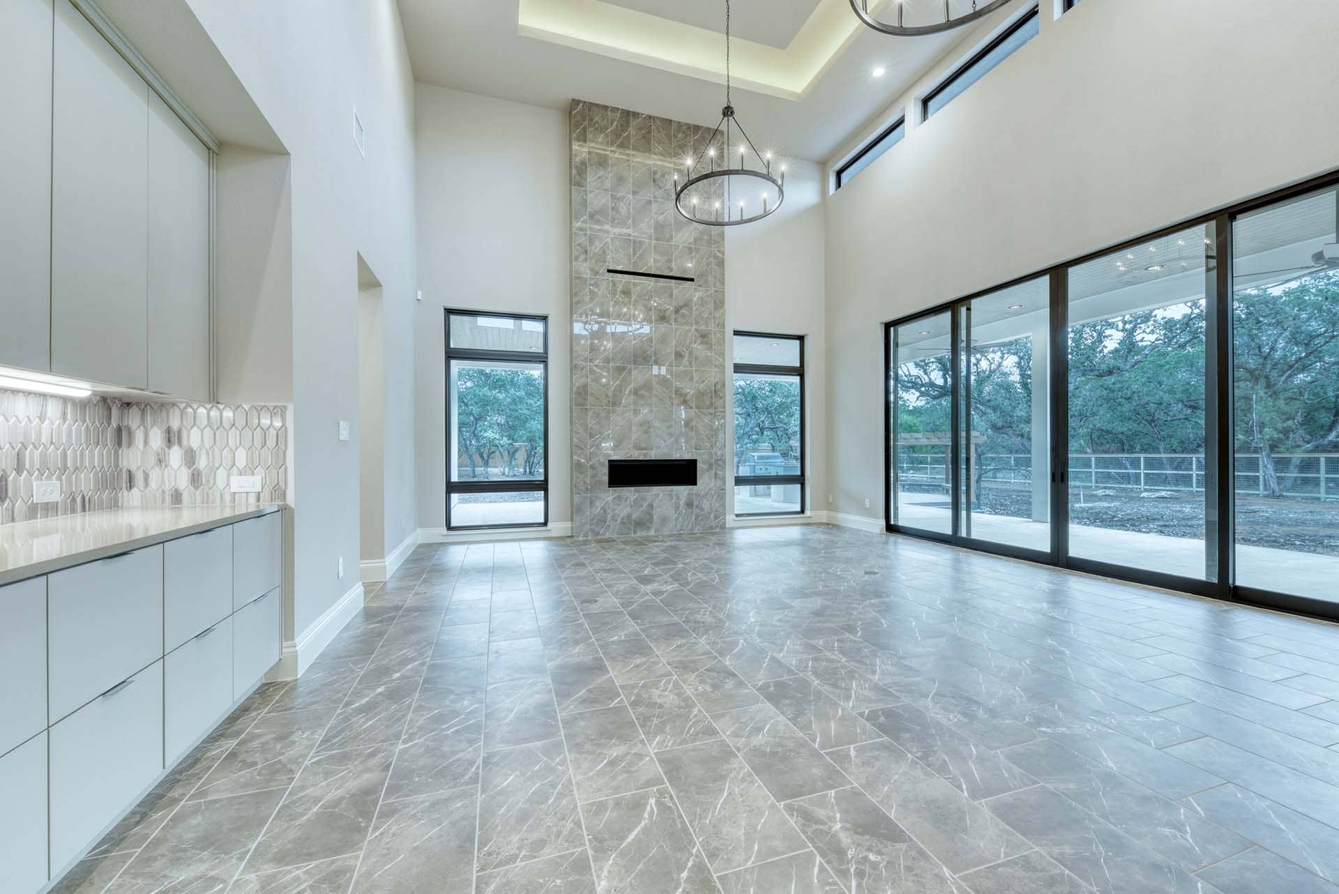 Modern living room with large windows and fireplace.