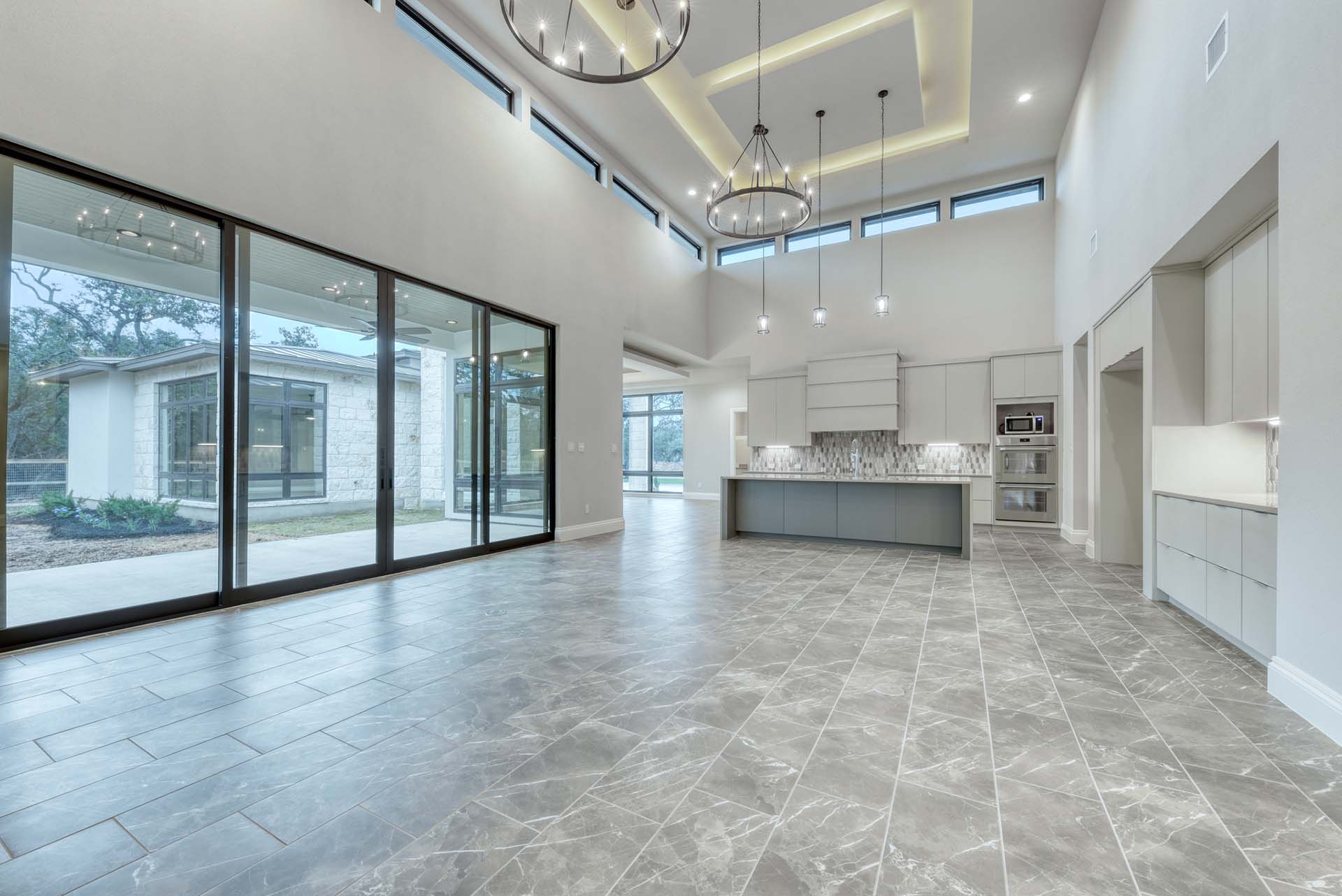 Spacious modern kitchen with large windows and lights.