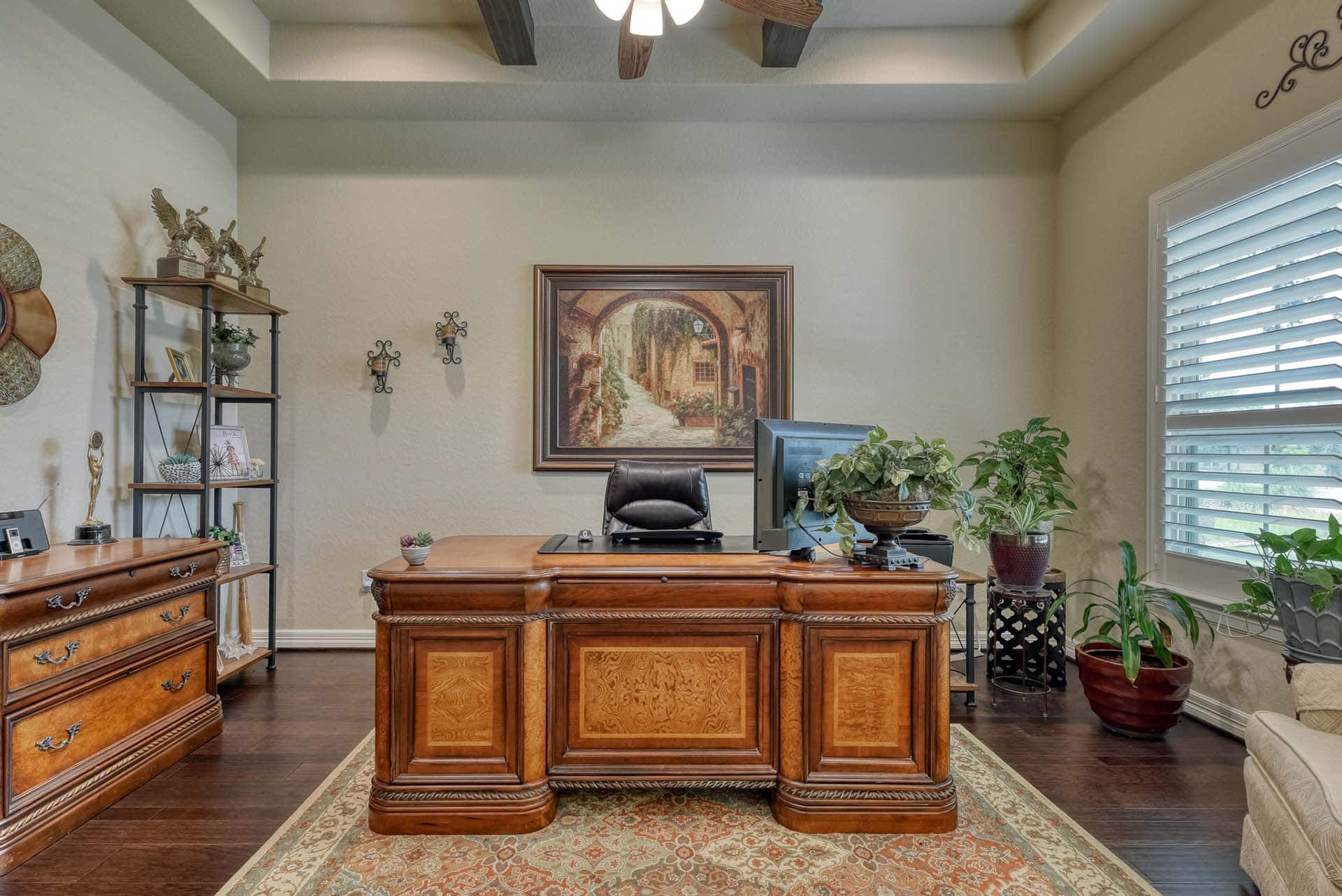 Elegant home office with wooden desk and decor.