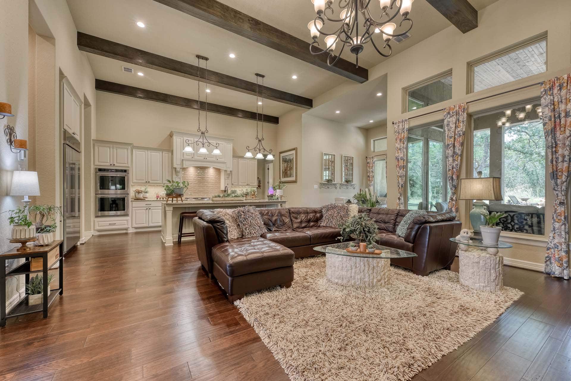 Luxury living room with modern kitchen and decor.