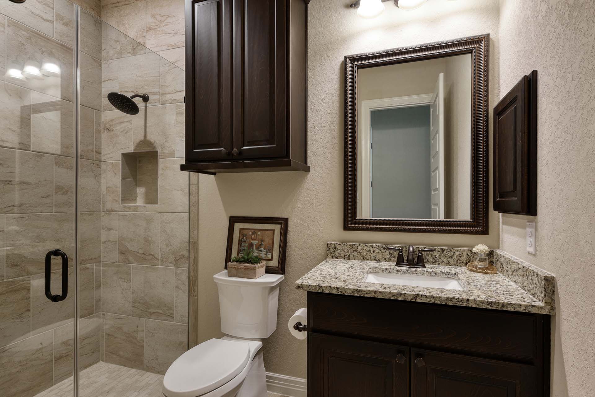 Modern bathroom with granite countertop and glass shower