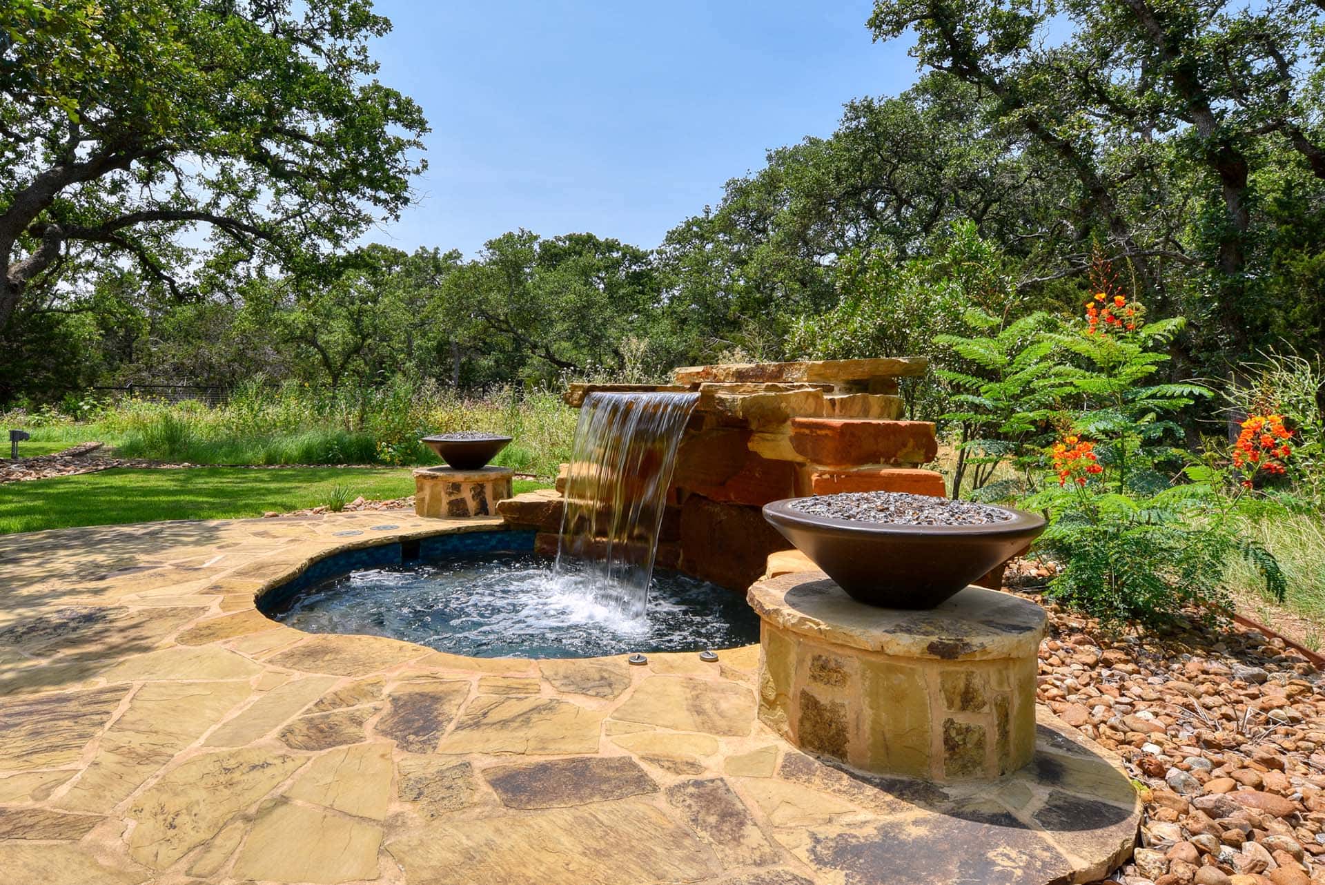Backyard stone pool with cascading waterfall.