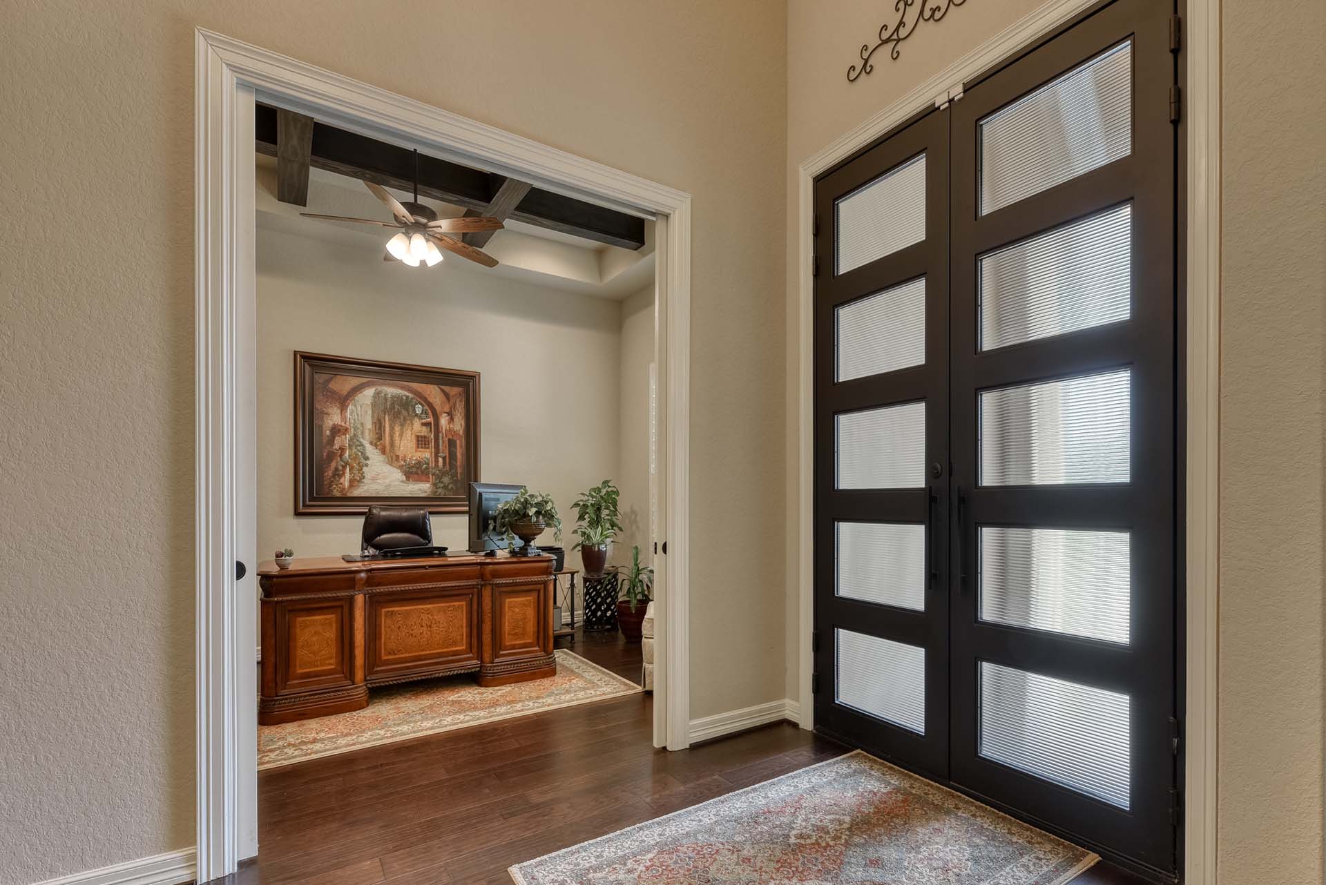 Elegantly decorated home office with wooden desk.