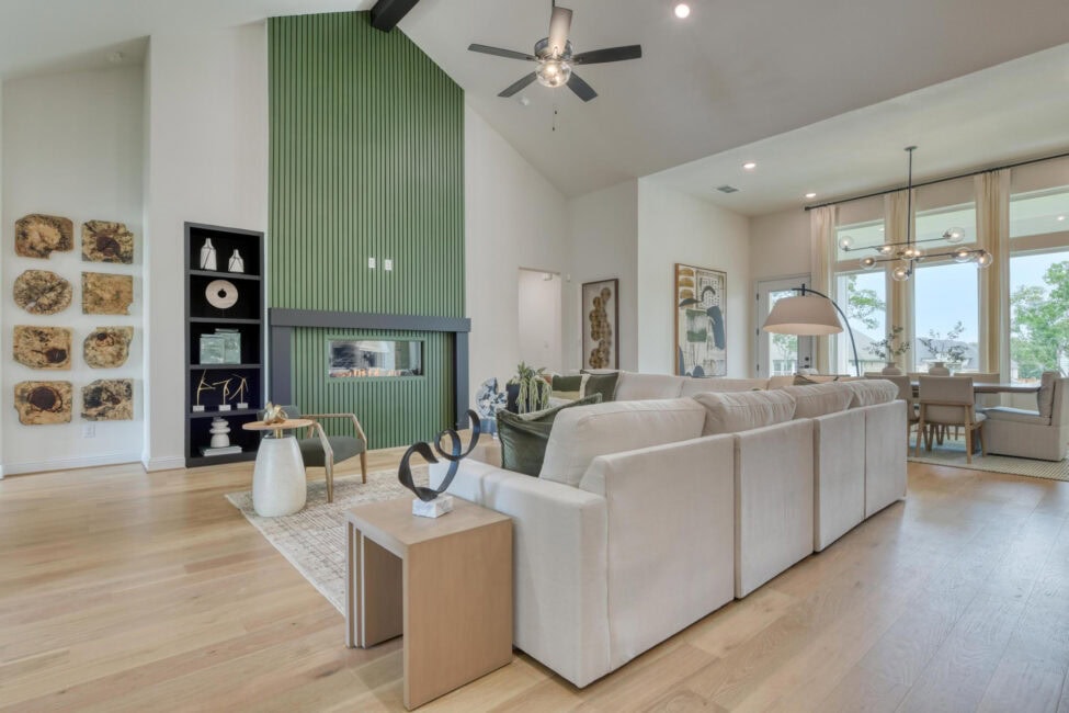 Modern living room with green fireplace feature wall.