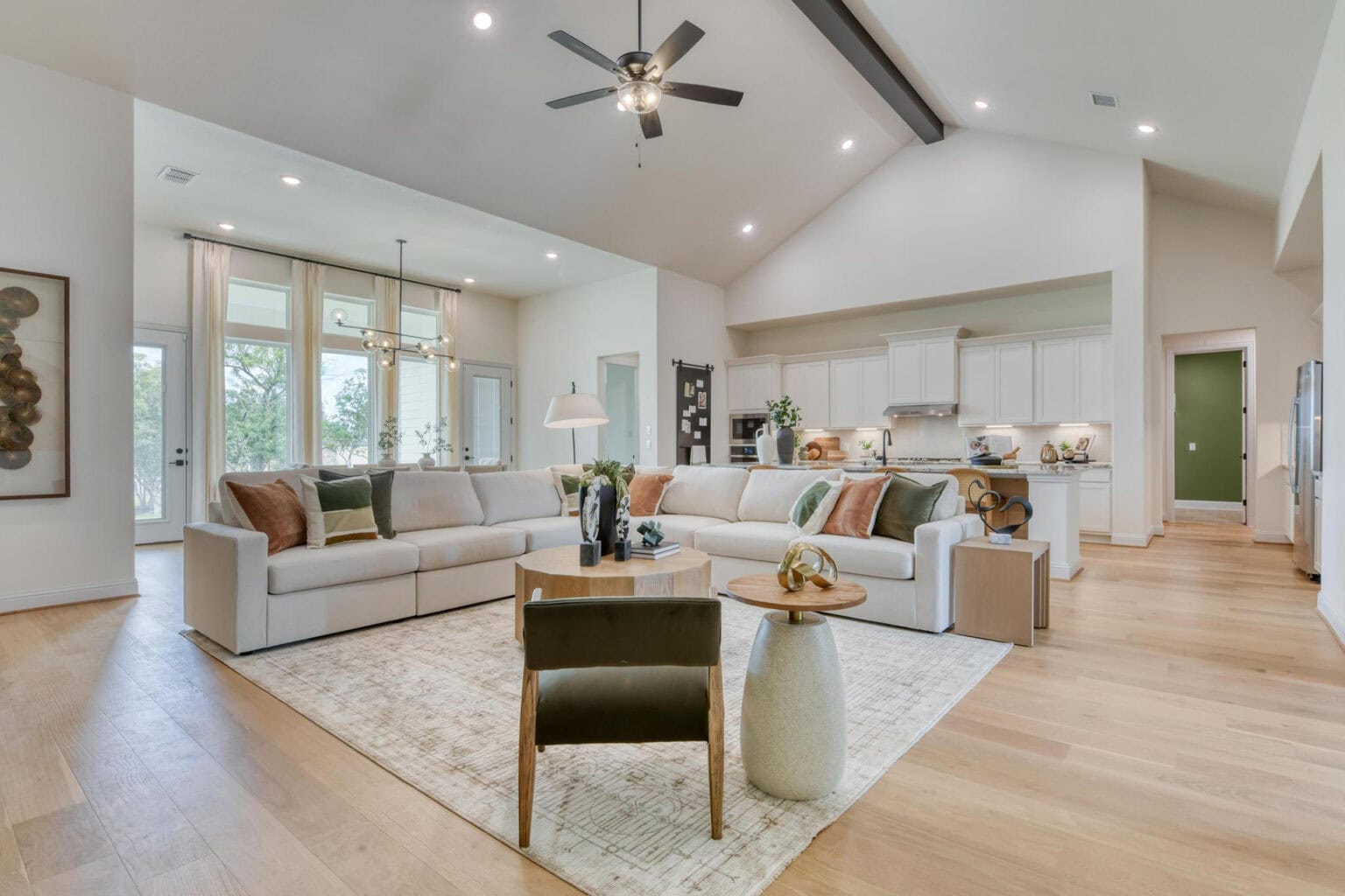 Spacious modern living room with kitchen view.