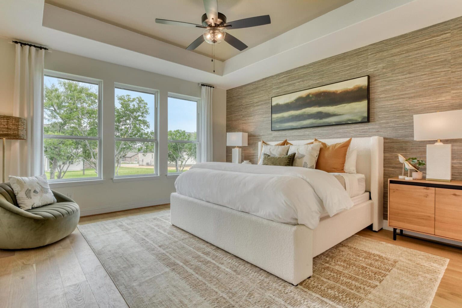 Modern bedroom with large windows and cozy decor.