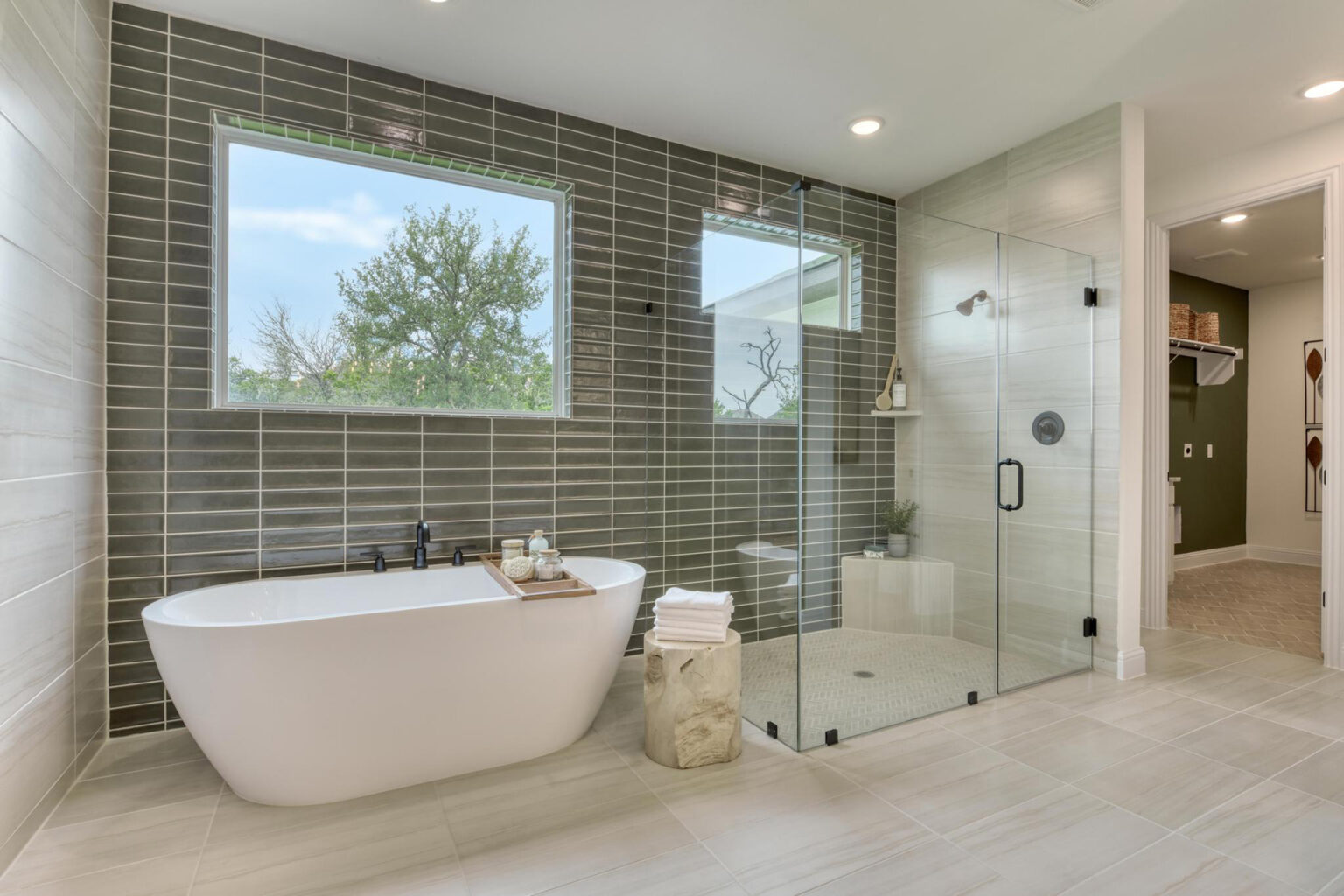 Modern bathroom with tub, shower, and window view.