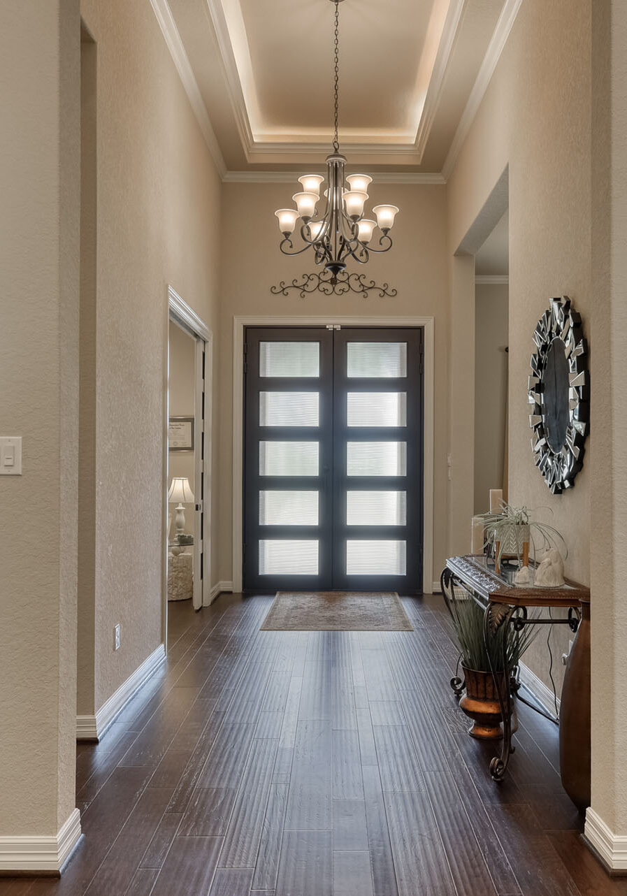 Elegant home entryway with chandelier and decor