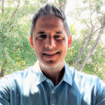 A man in a blue shirt smiling for the camera, Scott Hammok, Sales Oakmont Homes of Texas